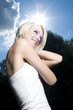 Beauty portrait of a woman against the sun