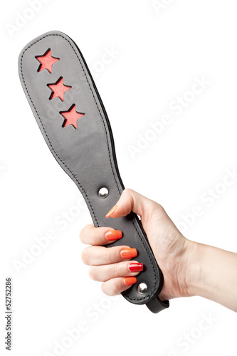 Photo: black leather fetish paddle in female hand isolated on white bac black leather fetish paddle in female hand isolated on white bac