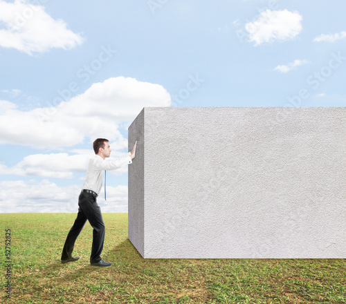 Photo: man pushing to cocnrete wall man pushing to cocnrete wall