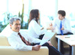 Photo: Businessmen discuss the deal. Businessmen discuss the deal.