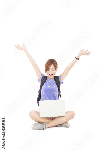 Photo: happy young Woman sitting and looking the laptop happy young Woman sitting and looking the laptop