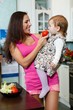 Mother with child in the kitchen.