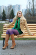 Photo: Cute girl in purple tights sitting on a bench. Cute girl in purple tights sitting on a bench.