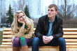 Photo: Romantic young couple sitting on bench at evening. Romantic young couple sitting on bench at evening.