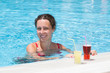 Woman swimming in the pool with near the drinks.
