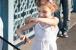Photo: Girl looking at the caught fish hanging on a hook. Girl looking at the caught fish hanging on a hook.