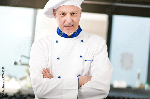 Photo: Mature chef in his kitchen Mature chef in his kitchen
