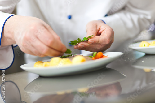 Photo: Chef garnishing a dish Chef garnishing a dish