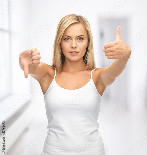 Photo: woman with thumbs up and down woman with thumbs up and down