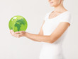 Photo: woman holding green sphere globe woman holding green sphere globe