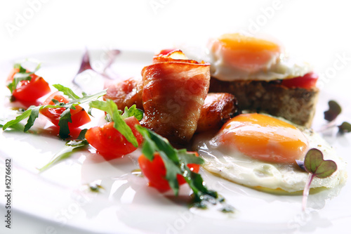 Photo: Scrambled eggs served with bacon and green Scrambled eggs served with bacon and green