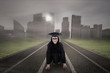 Asian graduate on racing track
