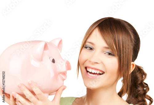 Photo: lovely girl with big piggy bank lovely girl with big piggy bank