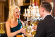 Photo: happy couple have a romantic date in restaurant happy couple have a romantic date in restaurant