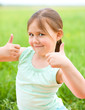 Little girl is showing thumb up gesture