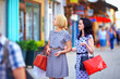 two beautiful women walking the city street