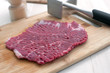 Raw steak piece and meat pounder