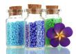 Photo: Little bottles full with colorful beads isolated on white Little bottles full with colorful beads isolated on white