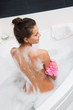 Beautiful young woman taking a bubble bath