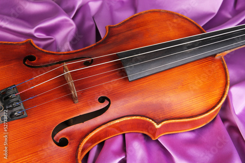 Photo: Classical violin on fabric background Classical violin on fabric background