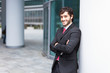 Businessman leaning on a column