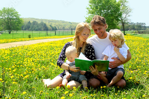 Photo: Family Reading in a Field of Dandelions Family Reading in a Field of Dandelions