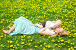 Mother Kissing Baby in Dandelion Field