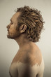 Dreaming, man covered in mud, naked, in profile, dirty skin