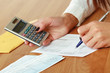 Young woman using a calculator