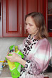 A woman wipes the glass with a towel