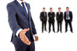 Photo: Business man offering handshake with businesspeople people on ba Business man offering handshake with businesspeople people on ba