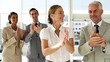Business people clapping at  the camera