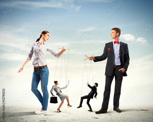 Photo: Businesspeople with marionettes Businesspeople with marionettes