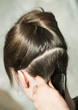 Closeup of combing back side hair part