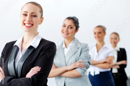 Photo: Four businesswomen standing in row Four businesswomen standing in row