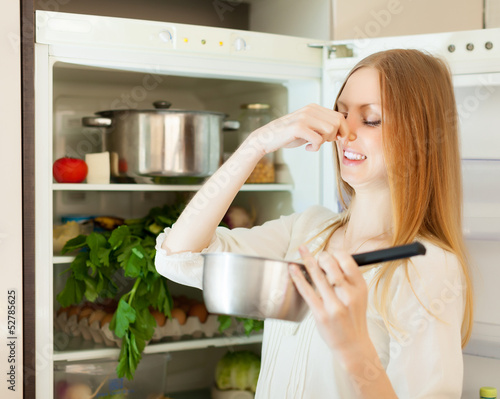 Photo: Long-haired woman holding foul food Long-haired woman holding foul food