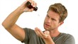 Video: Man pouring out pills on white background Man pouring out pills on white background