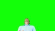 Man catching an orange segment with mouth on green screen