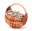 Herbal drug capsules in wicker basket. Alternative medicine conc