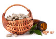 Herbal drug capsules in wicker basket. Alternative medicine conc