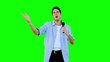 Man singing into microphone on green screen
