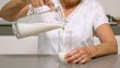 Woman pouring glass of milk