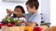 Siblings making salad together