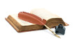 inkwell, pen and an old open book on white background