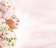 fashion model with  pink flowers in her hair.