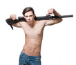 Sexy man semi nude holding a machine gun