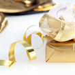 Photo: Pretty gold wrapped gift and twirled ribbon Pretty gold wrapped gift and twirled ribbon