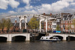 Amsterdam with boat against old bridge in Holland