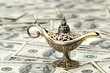 Photo: aladdin lamp on dollar background aladdin lamp on dollar background