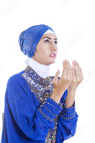 Photo: Beautiful girl in blue muslim dress on white Beautiful girl in blue muslim dress on white